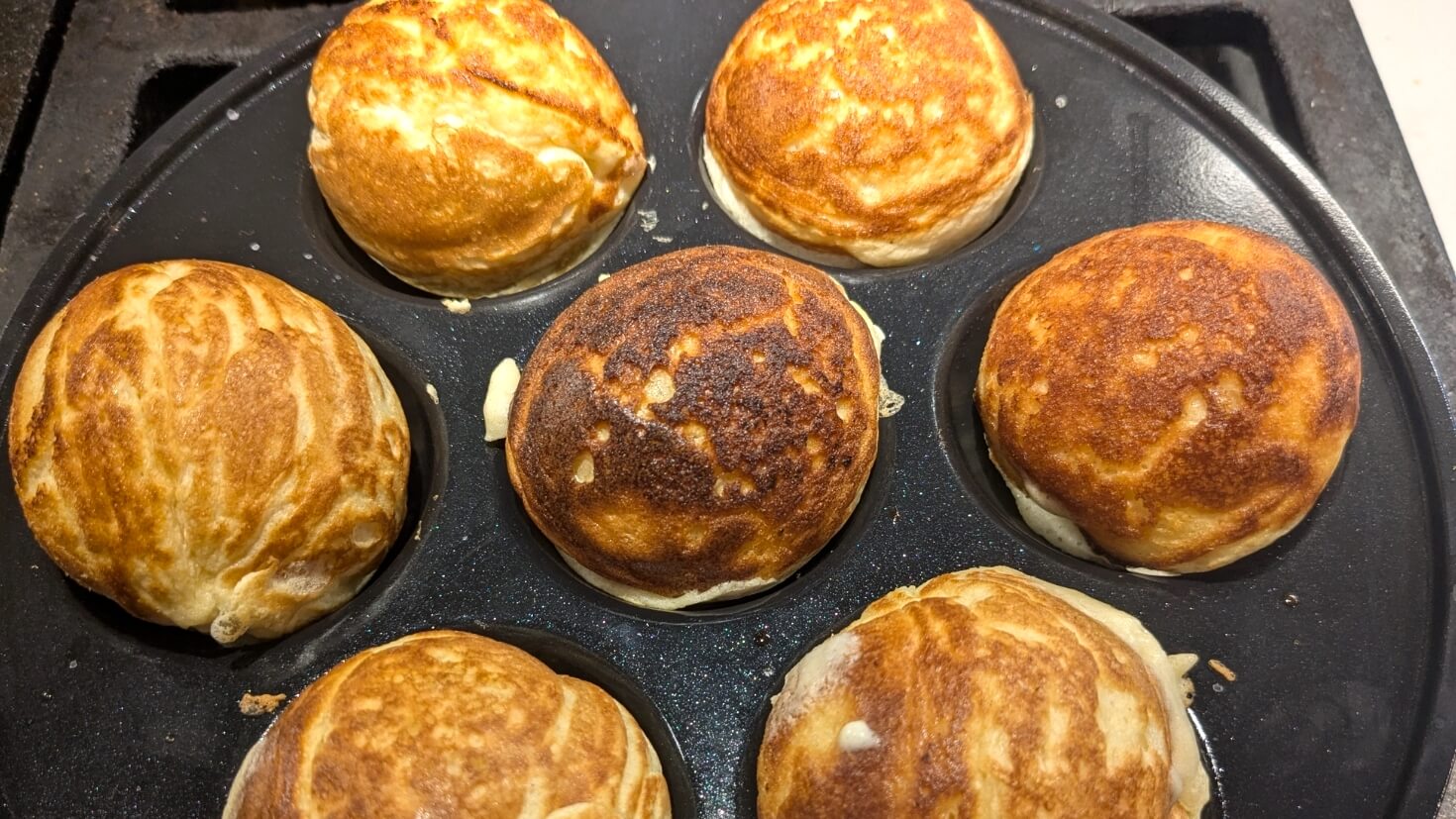 Cooked aebleskiver in an aebleskive pan
