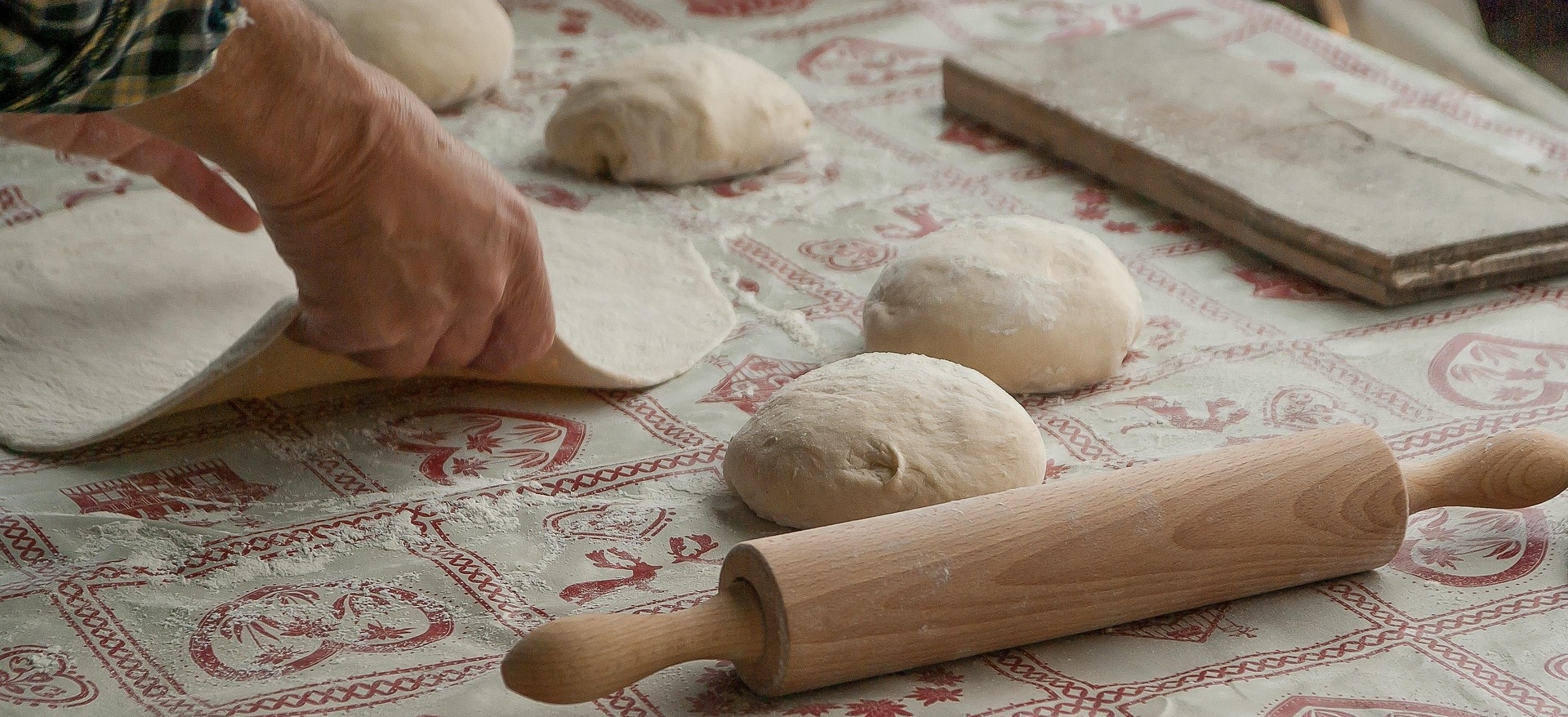 hands making dough with flour on the table